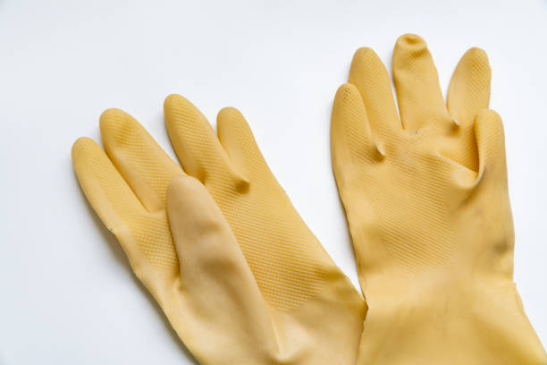 istock Yellow rubber gloves on white background 1347168936