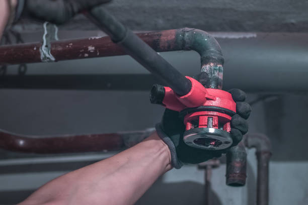 istock Professional plumber using a tread or thread tool to make treads on a metal pipe work for central heating or plumbing. 1347174371