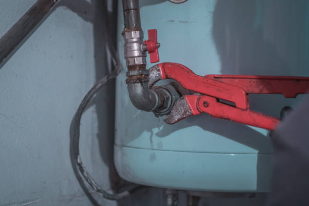 istock Professional plumber using clamps or spanner on a metal pipe work for central heating or plumbing. 1347174373