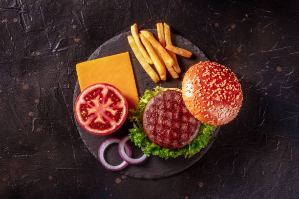 istock Burger ingredients, shot from the top on a black slate background 1347174690