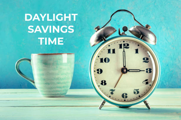 istock Daylight Saving Time concept. A retro alarm clock with a cup of coffee 1347174713