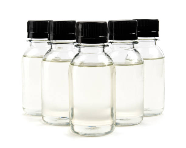 istock several bottles with black caps filled with transparent liquid. 1347176714