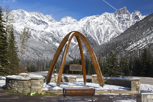 Rogers Pass Monument Arches celebrating the Opening of the Road on September 3, 1962 with Snowy British Columbia, Canada Selkirk Mountains Glacier National Park Landscape
