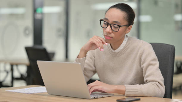 istock African Businesswoman Thinking using Laptop 1347180959