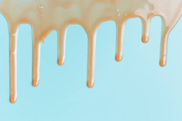 istock Moisturizing serum dripping on blue background, concept of natural cosmetics. 1347181969