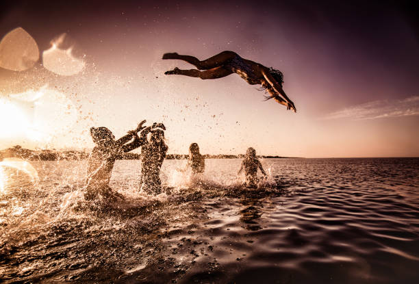 istock Fun in the sea at sunset! 1347182100