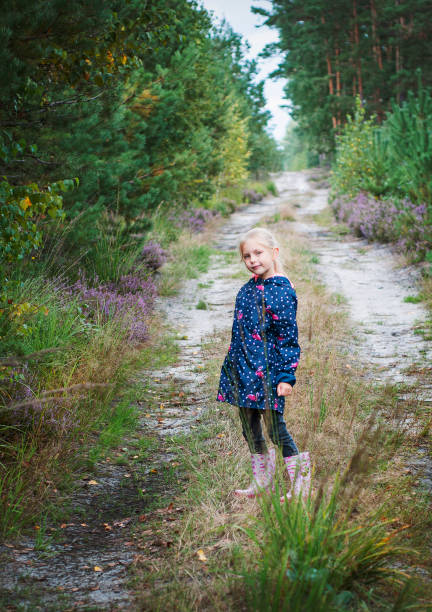 istock Little girl in an autumn forest 1347182813