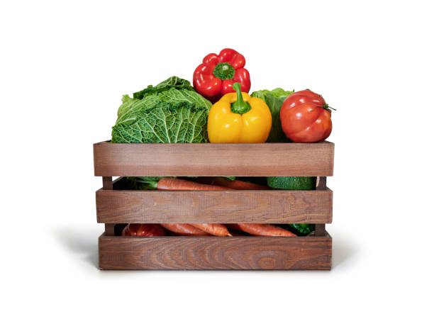 istock Fresh vegetables in a wooden box isolated from white background 1347185681