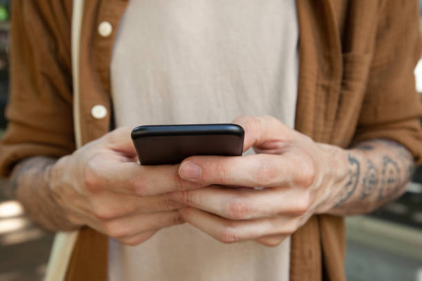 istock Male hands holding smartphone 1347188360