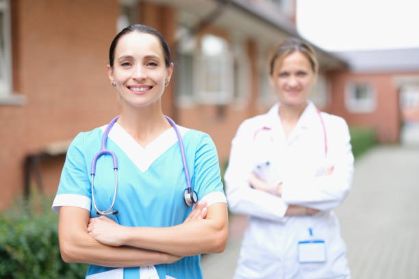 istock Two smiling female doctors stand with folded arms 1347189614