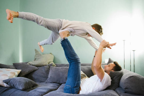 istock Father and son have fun together on the sofa 1347189999