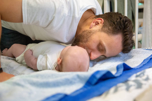 istock Love: father kisses his baby boy after changing his diapers 1347190838