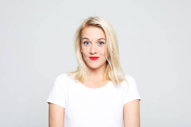 istock Young cute smiling blond woman wearing white t-shirt 1347190884