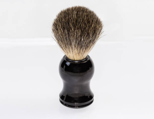 istock Shaving brush stands on a light surface, close-up 1347192358