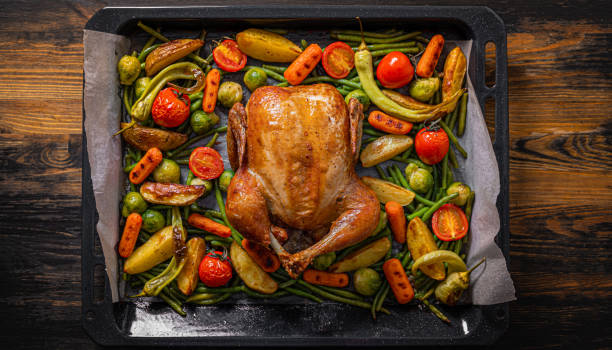 istock romantic dinner for two of baked chicken and baked vegetables 1347193133