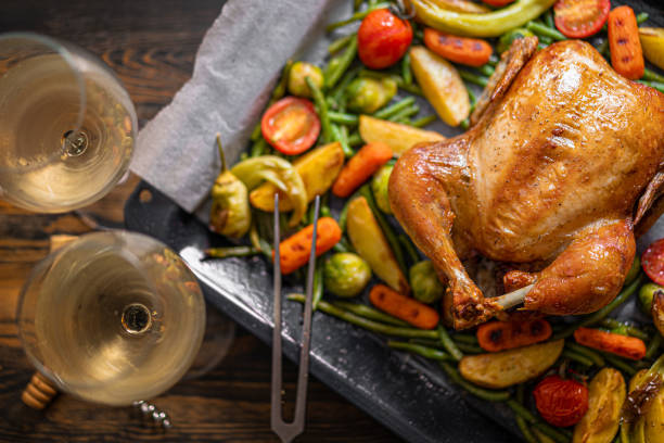 istock romantic dinner for two of baked chicken and baked vegetables 1347193161