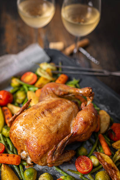 istock romantic dinner for two of baked chicken and baked vegetables 1347193174