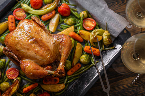 istock romantic dinner for two of baked chicken and baked vegetables 1347193175