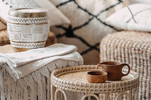 istock Wooden cup at wicker coffee table standing in living room 1347193279