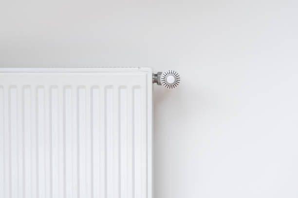 New modern radiator against white copy space wall New modern radiator against white copy space wall. Central heating system in contemporary house. Saving energy, consumption of natural resource and warm home concept radiator stock pictures, royalty-free photos & images