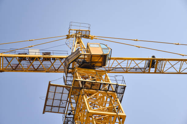 istock Tower crane at the construction site, against the blue sky 1347195035