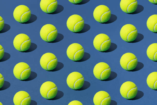 Arranged green tennis ball on blue background. Pattern. Arranged green tennis ball on blue background. Pattern. tennis tournament stock pictures, royalty-free photos & images