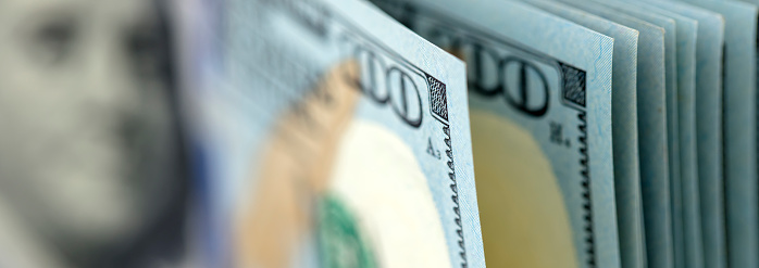 US $100 bills close-up. Shallow depth of field.