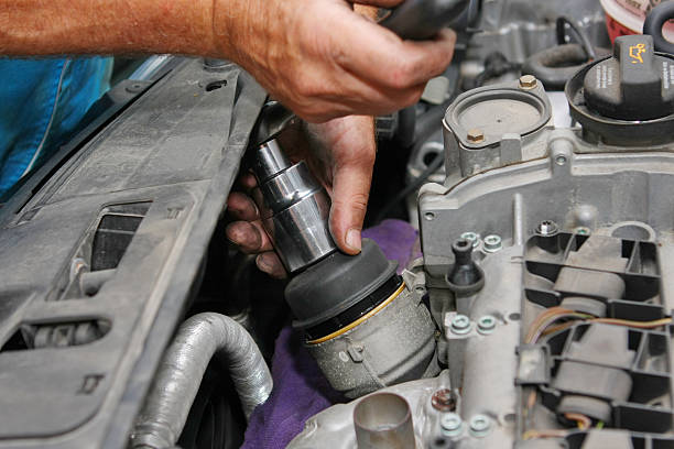 istock In auto repair shop....Car mechanic is fixing engine 134719943
