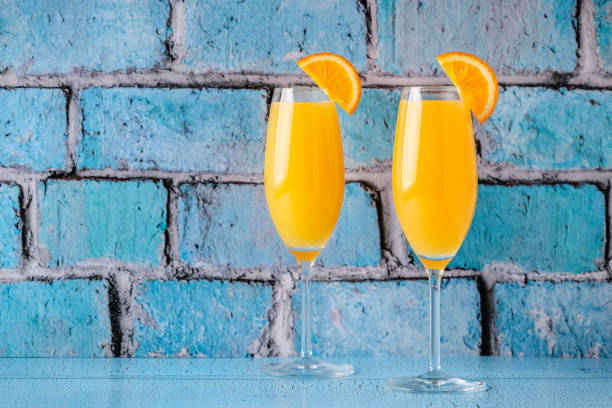 Refreshing orange Mimosa cocktails with champagne stock photo