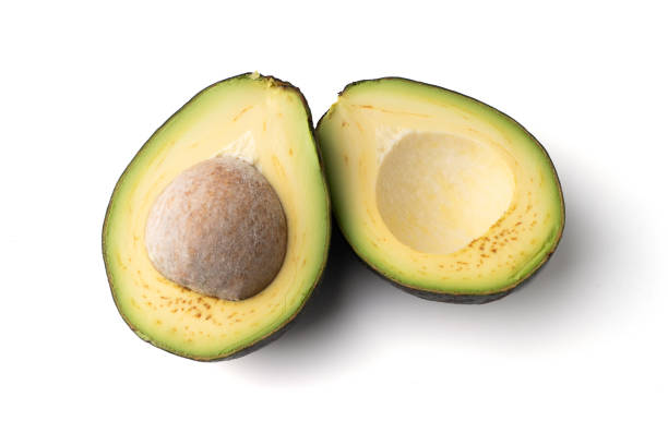 istock Avocado cut in half isolated on a white background 1347203358