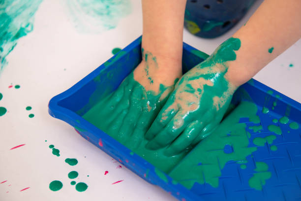 istock Kids hands with green paint 1347204023