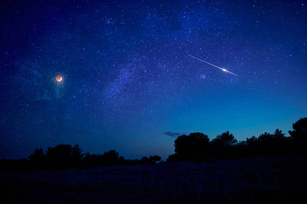 istock Landscape silhouette of a evening sky with crescent Moon eclipse, meteor, shooting star and planets. 1347206241