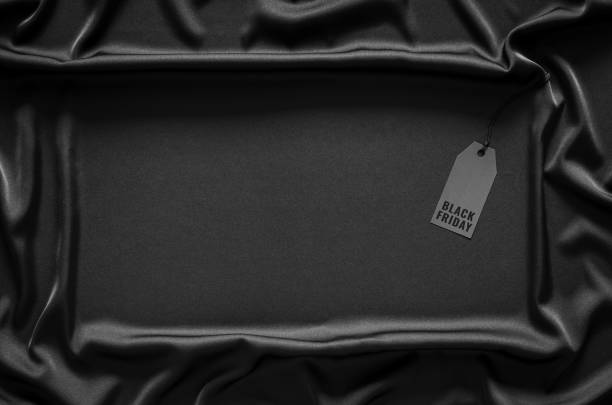 istock A black price tag on black smooth and wavy cloth 1347207521