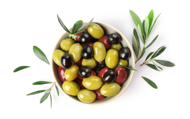istock Green, red and black olives in bowl isolated on white background 1347207964