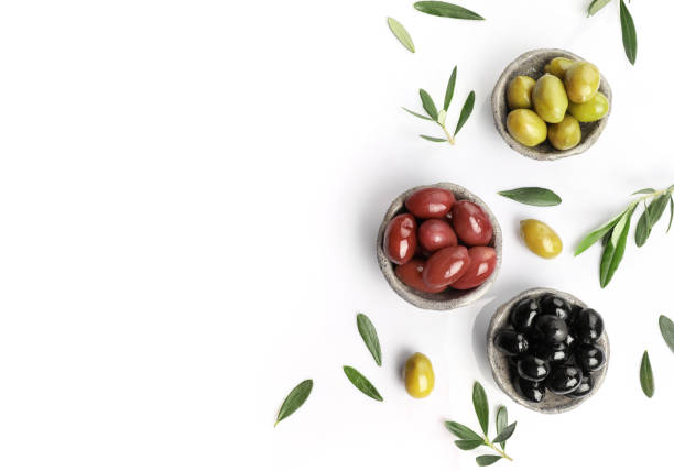 istock Green, red and black olives in bowls isolated on white background 1347207965