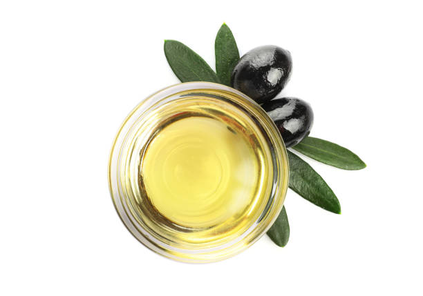 istock OBlack olives and olive oil in a bowl isolated on white. Top view 1347207968