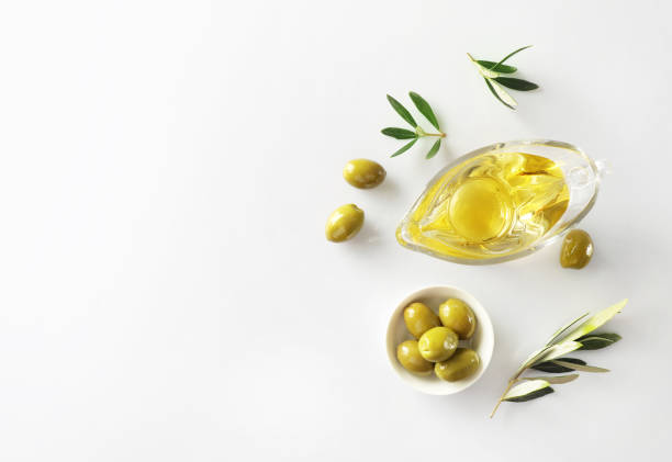 istock Olive branch and olive oil isolated on white background. Top view 1347207986