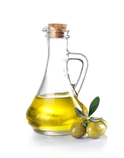 istock Green olives and olive oil pitcher isolated on white. 1347208088