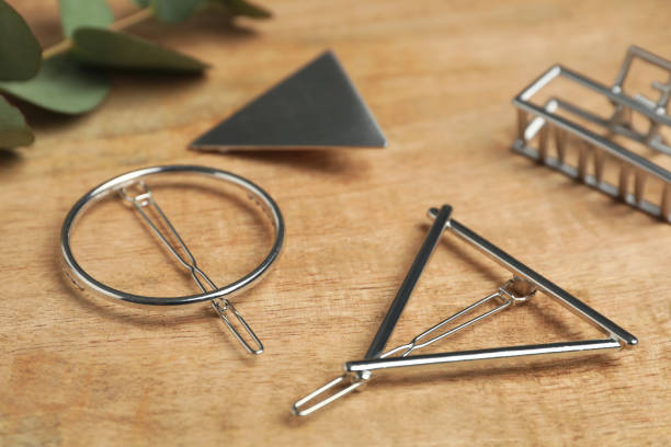 istock Stylish silver hair clips on wooden table 1347209221