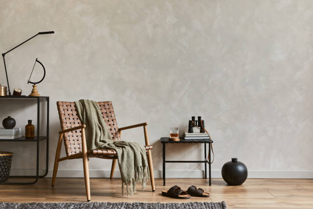 Creative interior design composition of elegant masculine living room with copy space, brown armchair, industrial shelfs and personal accessories. Template. Creative interior design composition of elegant masculine living room with copy space, brown armchair, industrial shelfs and personal accessories. Template. masculinity stock pictures, royalty-free photos & images