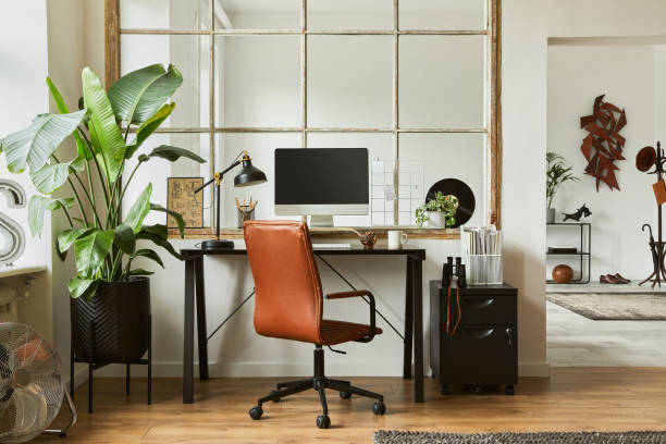 istock Creative workspace composition of modern masculine home office interior with black industrial desk, brown leather armchair, laptop, vintage record player and stylish personal accessories. Template. 1347211676
