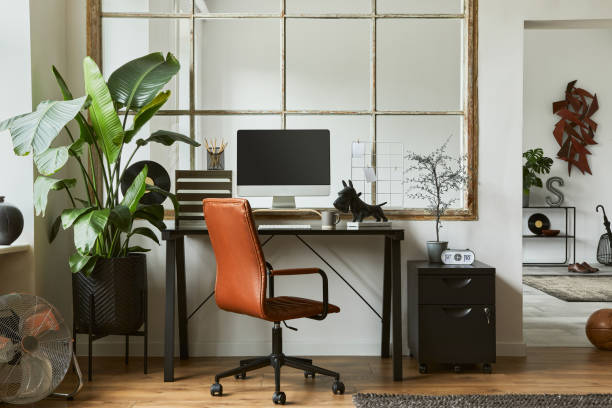 istock Creative workspace composition of modern masculine home office interior with black industrial desk, brown leather armchair, laptop, vintage record player and stylish personal accessories. Template. 1347211689