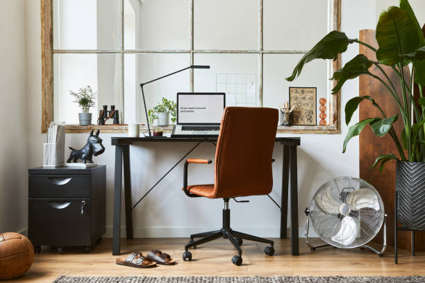 istock Creative workspace composition of modern masculine home office interior with black industrial desk, brown leather armchair, laptop, vintage record player and stylish personal accessories. Template. 1347211692