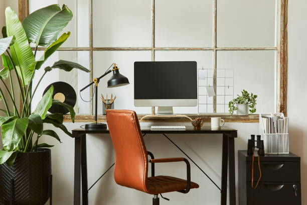 istock Creative workspace composition of modern masculine home office interior with black industrial desk, brown leather armchair, laptop, vintage record player and stylish personal accessories. Template. 1347211713