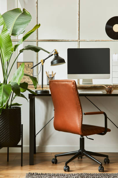 istock Creative workspace composition of modern masculine home office interior with black industrial desk, brown leather armchair, laptop, vintage record player and stylish personal accessories. Template. 1347211749