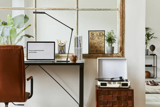 istock Creative workspace composition of modern masculine home office interior with black industrial desk, brown leather armchair, laptop, vintage record player and stylish personal accessories. Template. 1347211756