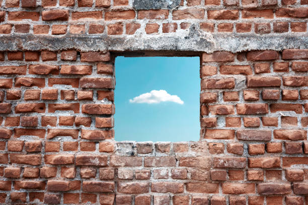 istock Ruined old brick wall window with sky and cloud view. Freedom, dream, imagination or isolation 1347212732
