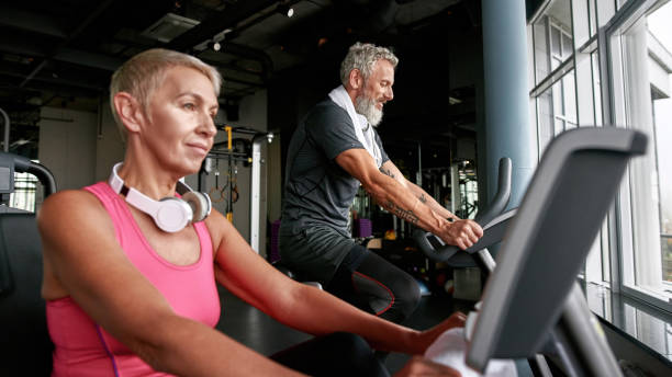 istock Senior couple doing cardio exercise on bikes in gym 1347213036