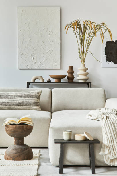 istock Creative interior composition of cozy living room with mock up poster frame and structure painting, corner sofa, coffee table, textile and personal accessories. Scandinavian classic style. 1347213037