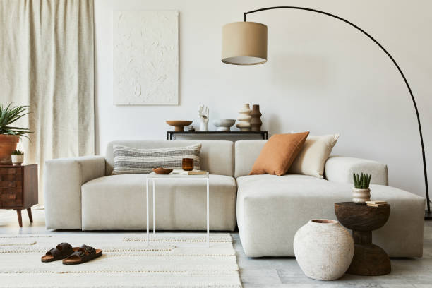 istock Creative composition of cozy living room interior design with mock up poster frame and structure painting, corner sofa, coffee table, textile and personal accessories. Scandinavian classic style. 1347213052